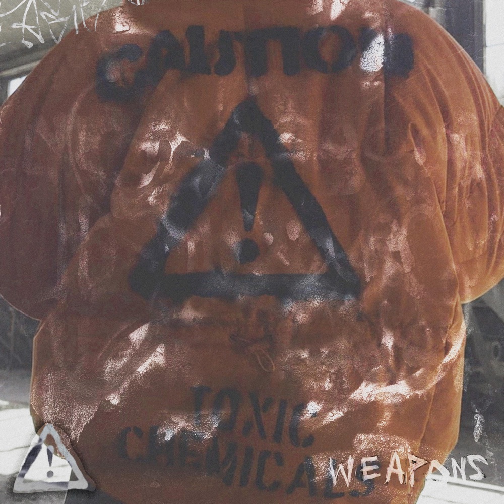 WEAPONS cover art: an orange coat spray-painted CAUTION, TOXIC CHEMICALS